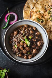 Chole is slow cooked chickpea curry in  lots of spices to make a creamy, rich curry which is served with Kulcha, Tandoori roti or Batura.