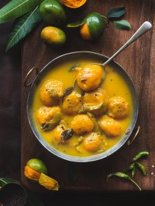 Maavina Hannu Gojju is the mango curry made using the mini mangoes called 'Sakkare guthi' . Maavina Hannu Gojju is a spicy, tangy and sweet mango curry.