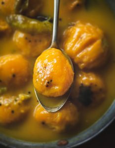 Maavina Hannu Gojju is the mango curry made using the mini mangoes called 'Sakkare guthi' . Maavina Hannu Gojju is a spicy, tangy and sweet mango curry.