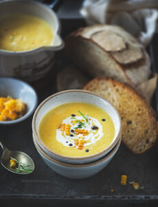 Corn soup is a creamy, light soup that is flavoured using garlic, rosemary and is served with a slice of crusty sourdough bread.