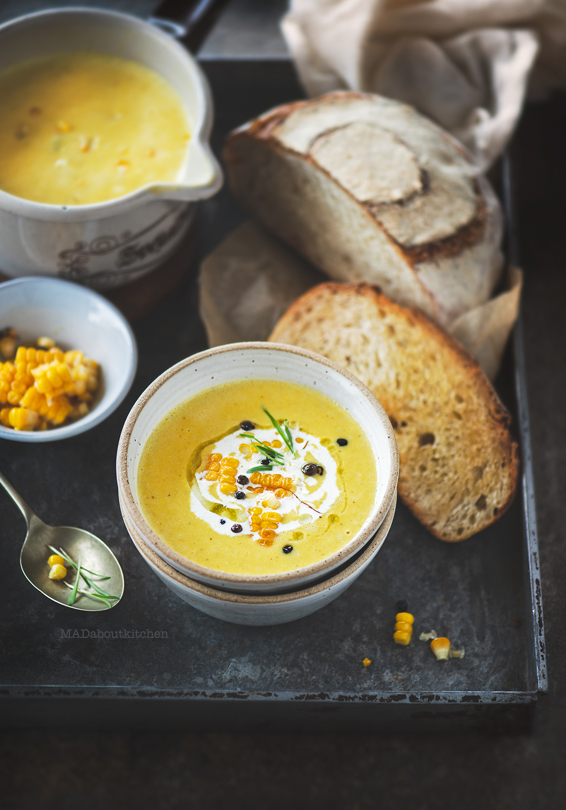 Corn soup is a creamy, light soup that is flavoured using garlic, rosemary and is served with a slice of crusty sourdough bread.