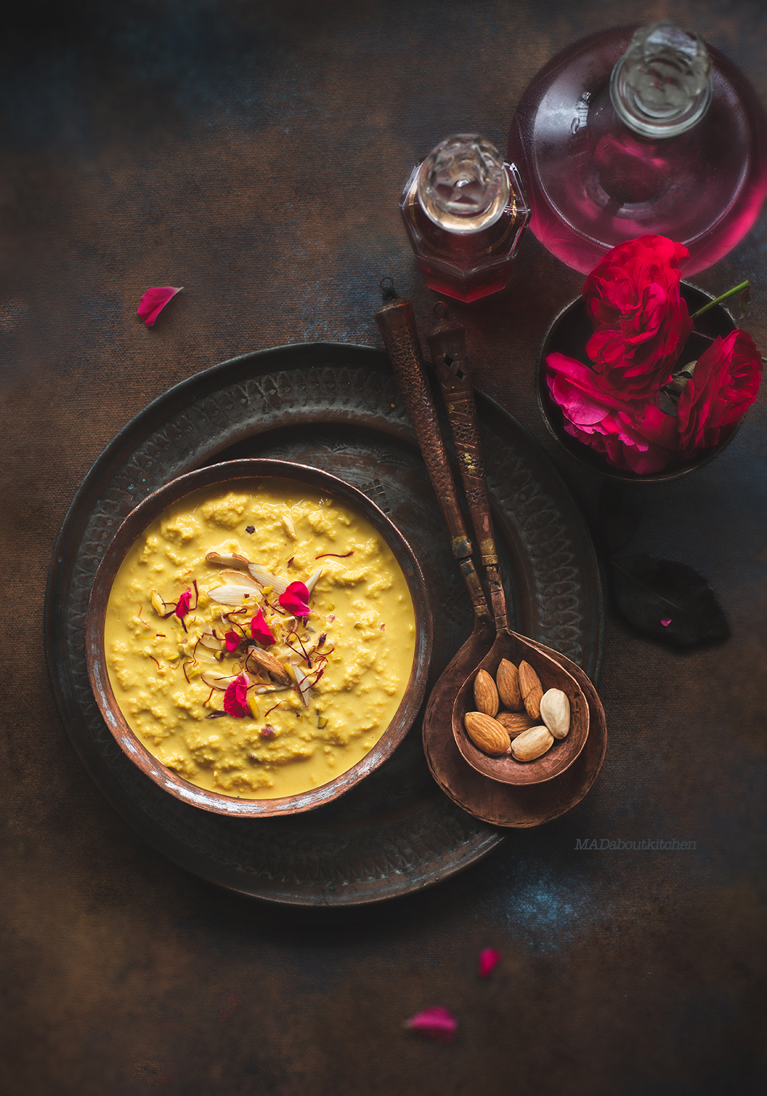 Rabdi, is an Indian dessert made by reducing whole milk to layers of cream. It is flavoured using saffron & is garnished with almonds & rose petals.