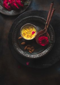 Rabdi, is an Indian dessert made by reducing whole milk to layers of cream. It is flavoured using saffron & is garnished with almonds & rose petals.