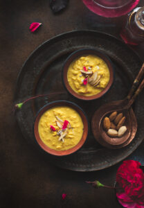 Rabdi, is an Indian dessert made by reducing whole milk to layers of cream. It is flavoured using saffron & is garnished with almonds & rose petals.