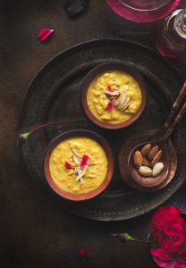 Rabdi, is an Indian dessert made by reducing whole milk to layers of cream. It is flavoured using saffron & is garnished with almonds & rose petals.