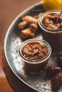 Wash peel and grate fresh ginger. Grind dates, 2Tbsp ginger and salt into paste. Try not to use water to grind. If you are not able to grind it without water then use as less as you can. Transfer it into a bowl. Mix the remaining ginger and lemon juice.  The chutney should have a hit of spice from ginger and should be tangy. Try and adjust that at this stage. Put it in an airtight container and refrigerate.