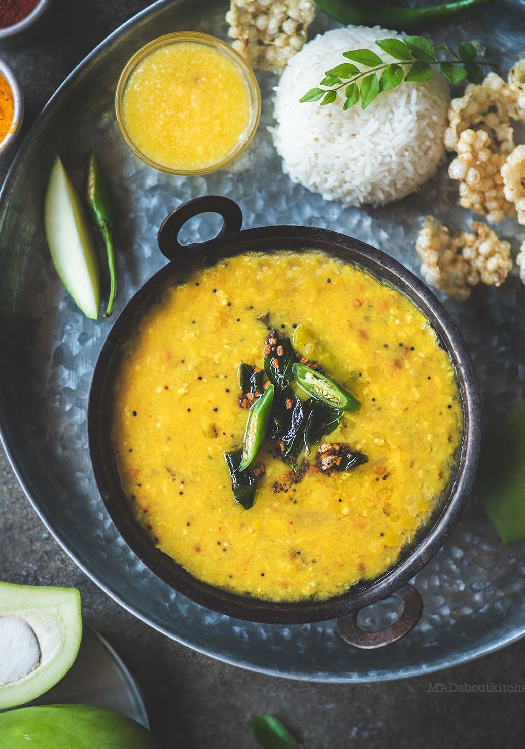 Mamidikaaya Pappu or the raw mango curry is a speciality from Andhra Pradesh. The sour ,spicy curry is served with steamed rice and ghee and some fryums.