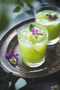 Method Peel the Cucumber and chop off the ends. Chop them into cubes and put them in a blender Add ice cubes, lemon juice, basil leaves and sugar or honey. Add 2 cups of water and blend it till cucumber is blend completely.  I use Vitamix which is an extremely fabulous blender and it blends it completely. Strain the lemonade to remove any fibrous particles in it. Serve it chilled and Enjoy!