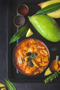 Paluvu or the raw mango curry is a lipsmacking, spicy, sweet, tangy raw & thick curry made using Tothapuri mango and can be served with almost everything.