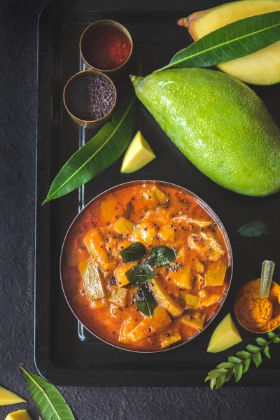 Paluvu or the raw mango curry is a lipsmacking, spicy, sweet, tangy raw & thick curry made using Tothapuri mango and can be served with almost everything.
