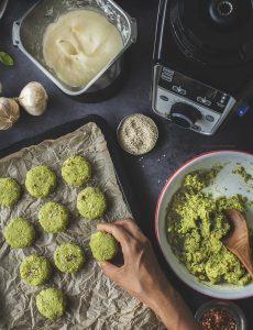 1 cup - Chana dal1/2 cup - fresh Coriander leaves1 - small onion, quartered2 Tbsp - Ginger garlic cloves, peeledSalt to taste1 Tbsp ground cumin1 Tbsp - Paanch phoran3 - Green chilliesSalt to taste2 Tbsp toasted sesame seeds1 tsp - Chilly flakes Soak chana dal in water for at least 4 hours. When ready, drain the dal completely and pat them dry.Add the coriander, cumin, onions, ginger garlic paste, green chillies, paanch phoranto Hamilton Beache’s small jar. Set on preset wet hard + coarse run the blender till all the ingredients cometogether. You may have to scrape the sides of the jar to help it blend evenly. Transfer the tikki mixture to a container and cover tightly. Refrigerate for at least 1 hour or until ready to cook.Preheat the oven to 180º C.Line the tray with baking paper.Add sesame seeds to the tikki mixture and stir with a spoon.Scoop tablespoonfuls of the tikki mixture and form into patties (½ inch in thickness each). Place the patties on the baking tray and sprinkle sesame seeds and chilly flakes on top.Bake for 15 mins on each side. Brush it with melted butter before flipping it.  Once they are brown enough take them out and servethem with the Garlic Dip.
